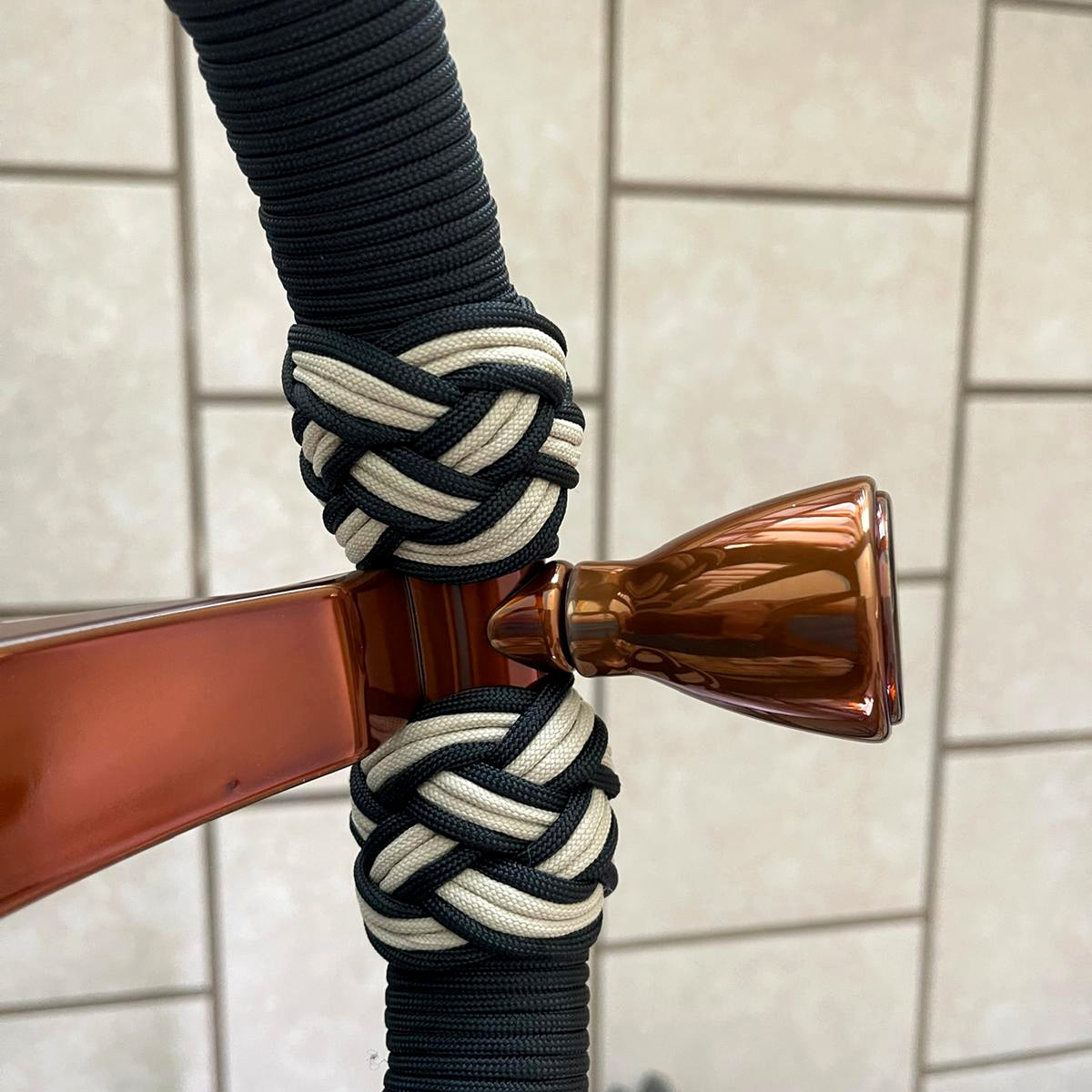 Detalle de rayo en acabado cobre con nudos negros y crema